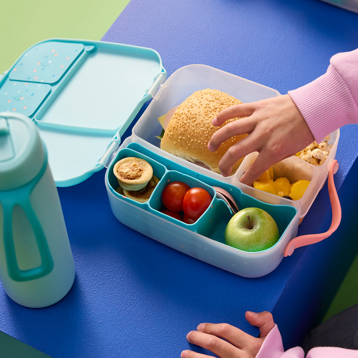 A light blue three-compartment plastic organizer tray with small colorful polka dots, shown on a plain white background.