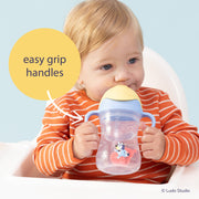Child holding a Bluey sippy cup with 'easy grip handles' text and Ludo Studio logo.