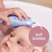 Hand scrubbing the Silicone Baby Bath Brush's Soft Bristles on Baby's Wet Head