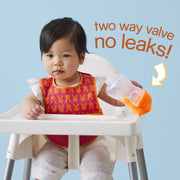 child with sippy cup - pink pomegranate - b.box for kids